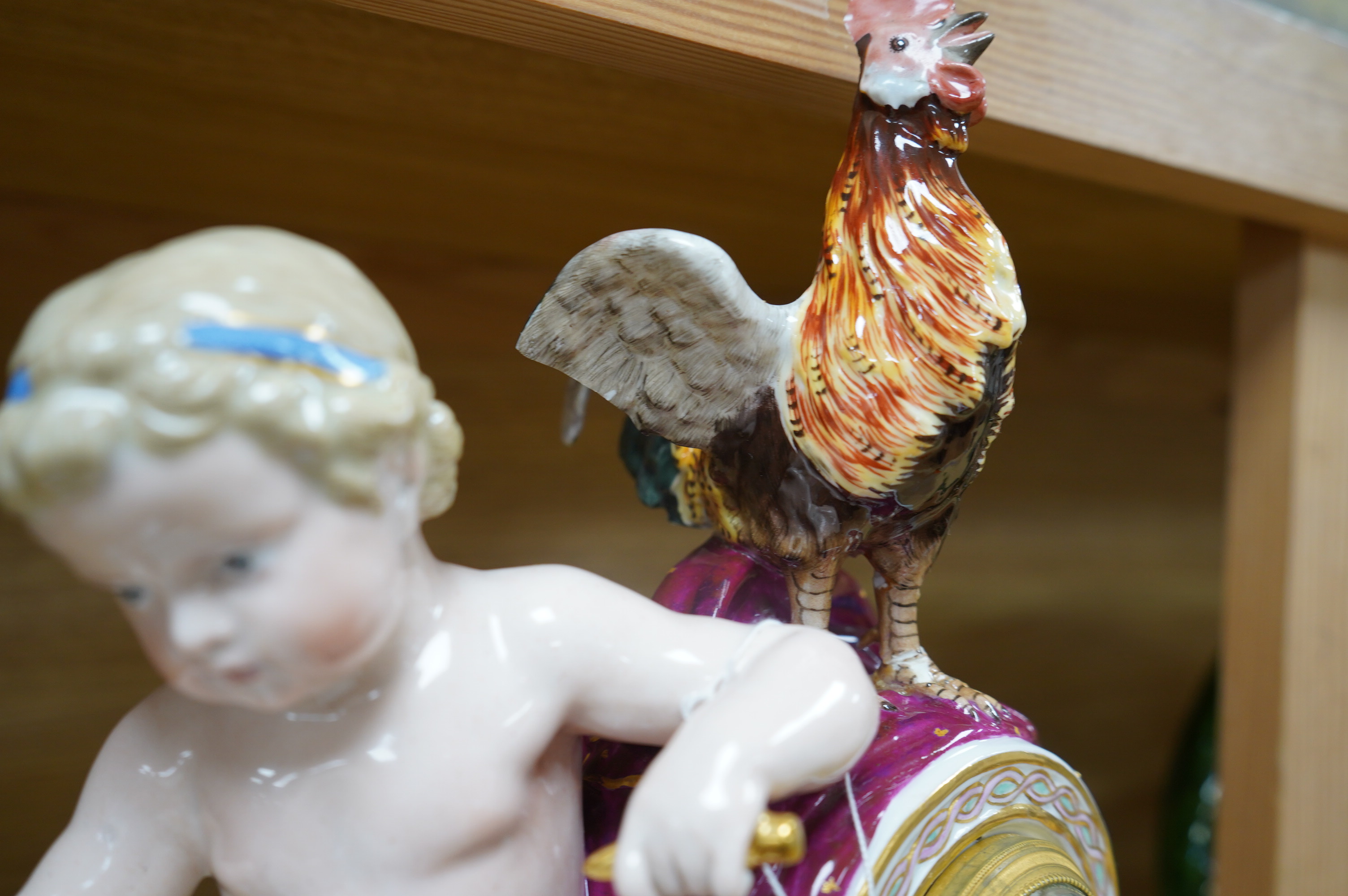 A Meissen figural mantel clock with cockerel surmount, French movement striking on a bell, 29cm high. Condition - poor